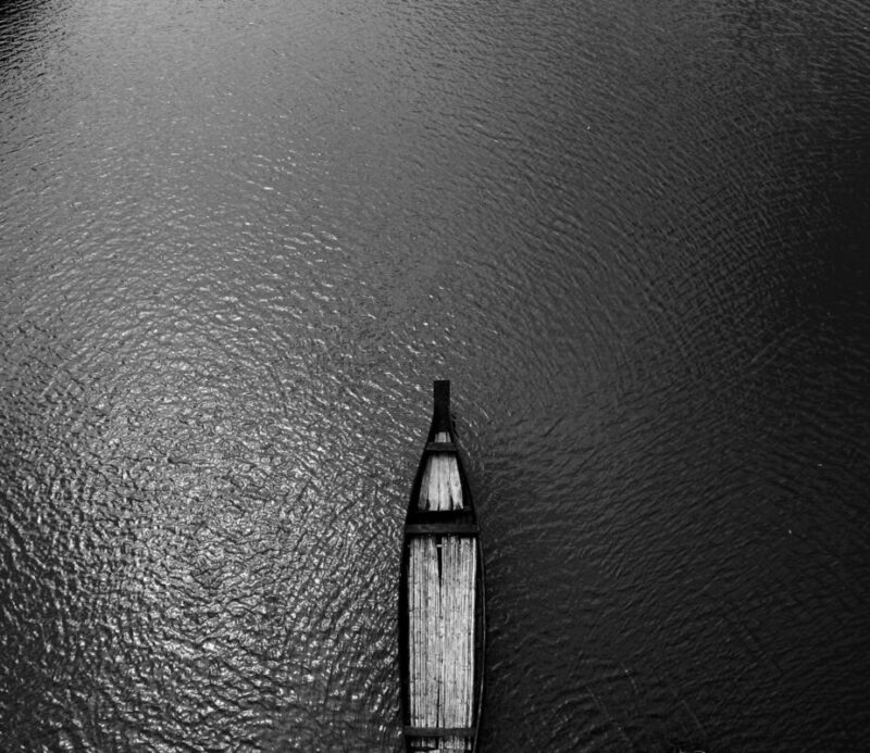 Aerial View Black Wooden Row Boat on Body of Water