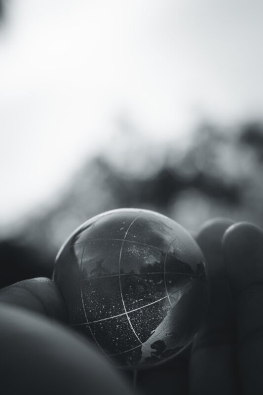 grayscale photo of person holding ball